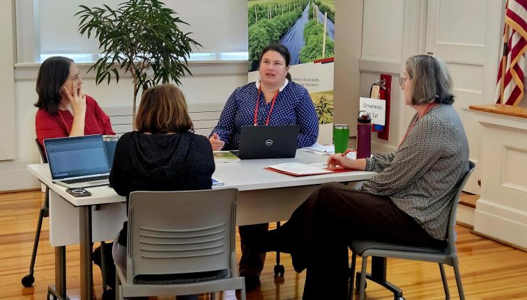 Four people seated around a table