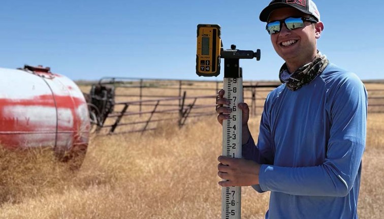 Person standing in a field with instruments