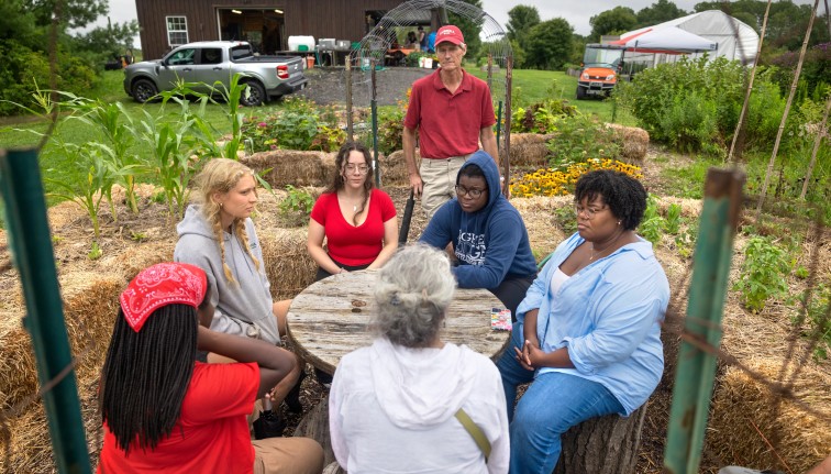 Students and staff meet at a Dilmun Hill student farm open house.