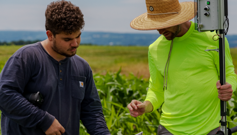 men working in field with electronic digital tools