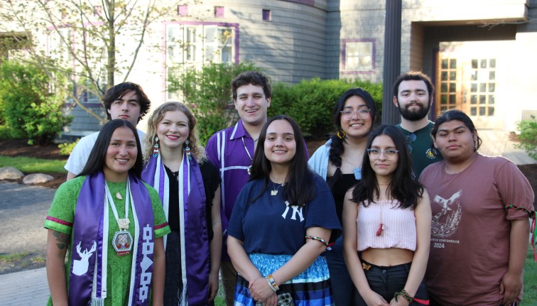 Students stand in front of Akwe:kon smiling.