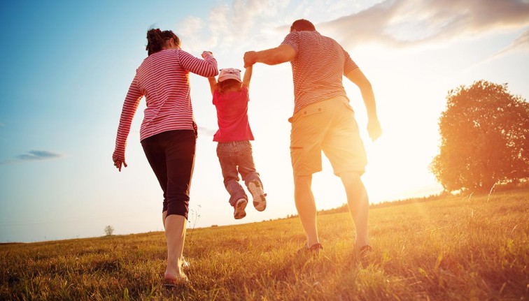 parents holding up their kid