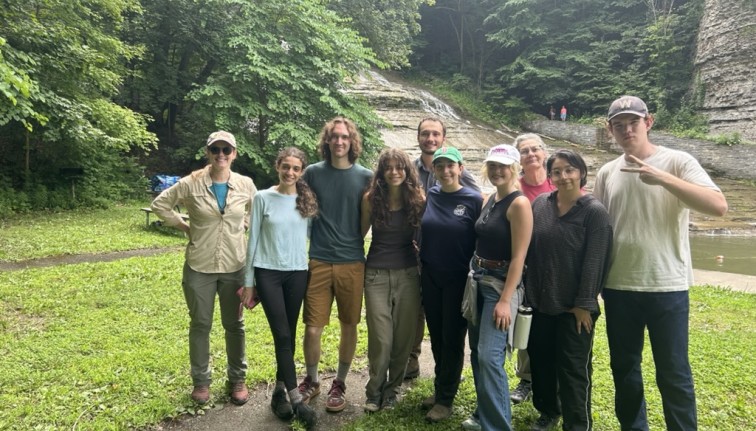 students in front of a waterfall in ithaca area