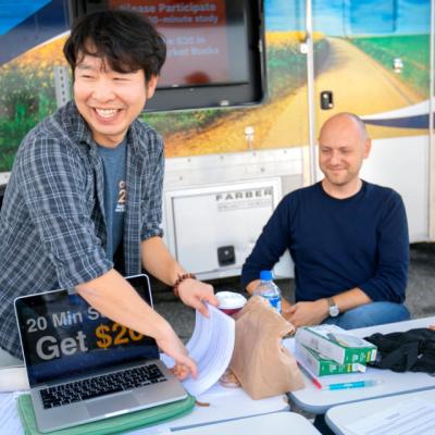 Students and Professors set up a table for a research study