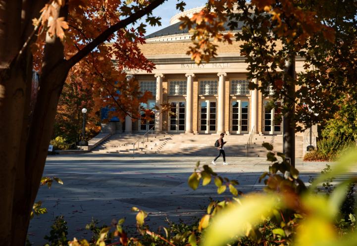 Student walks in front of campus building