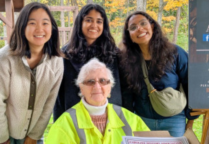 Students post with local volunteer