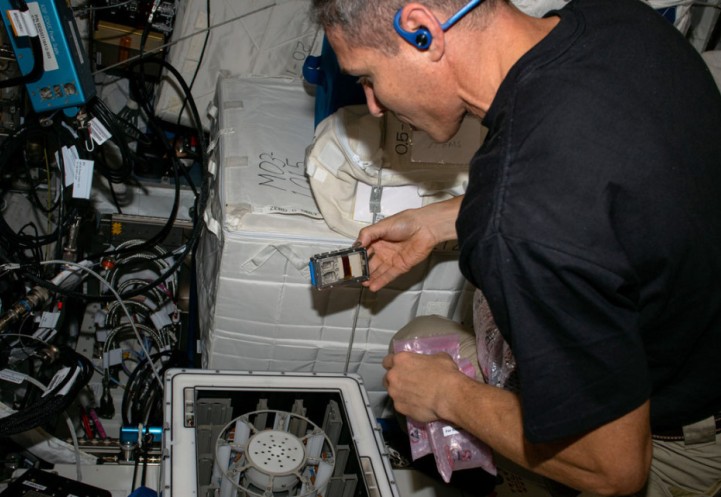 Michael Scott Hopkins performs a microgravity experiment on the International Space Station