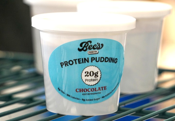 A white cup with a blue label on the side. 