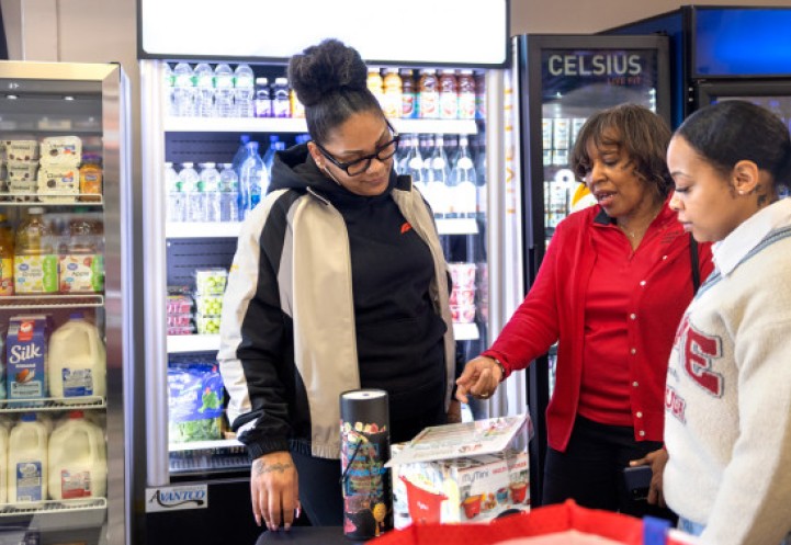 Sheila Bass, program manager of CCE Erie’s Healthy Community Store Initiative, talks about nutrition with Jasmine Robbs , a customer at Buffalo’s Golden Corner store, and Moet Grooms, a CCE educator with the Healthy Community Store Initiative