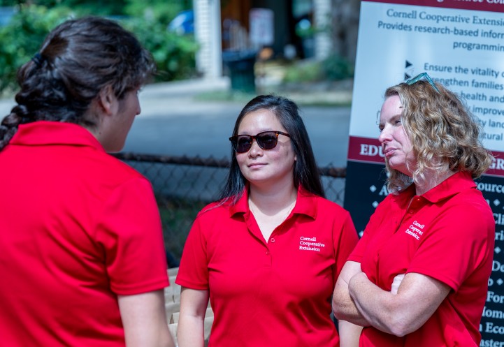 Mallory Hohl speaks with colleagues at the South Lawn garden in Rochester, NY.