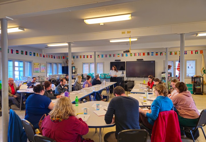A group of people gathered in a class room. 