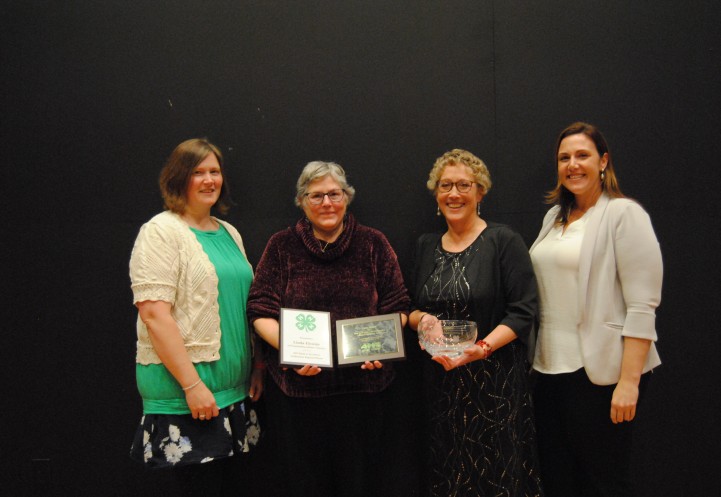 Linda Elcsisin recieving award with Alexa Maile and others