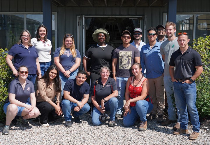 A group of people stand together in front of the facility at the Miner Institute.