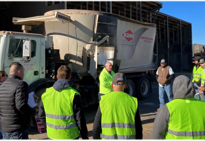 people standing by a mixer wagon