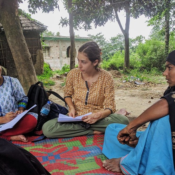 Isabella Culotta sitting outside with Napalese women