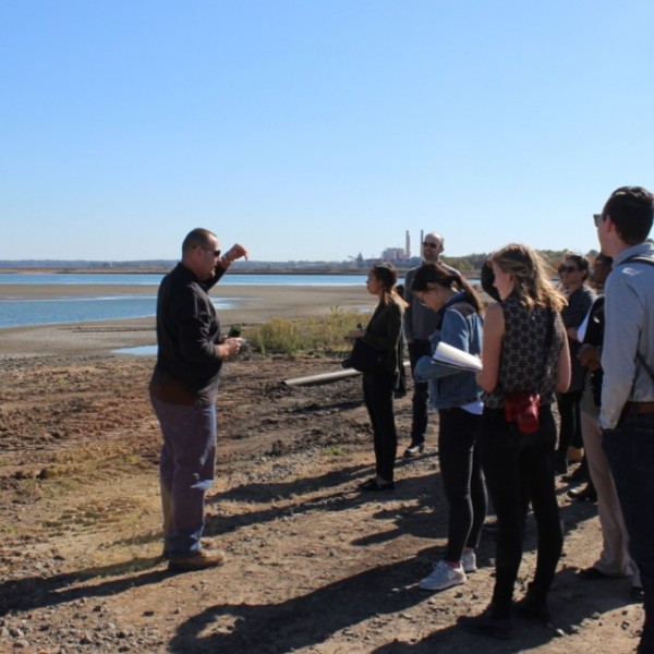 students and professor on river bank
