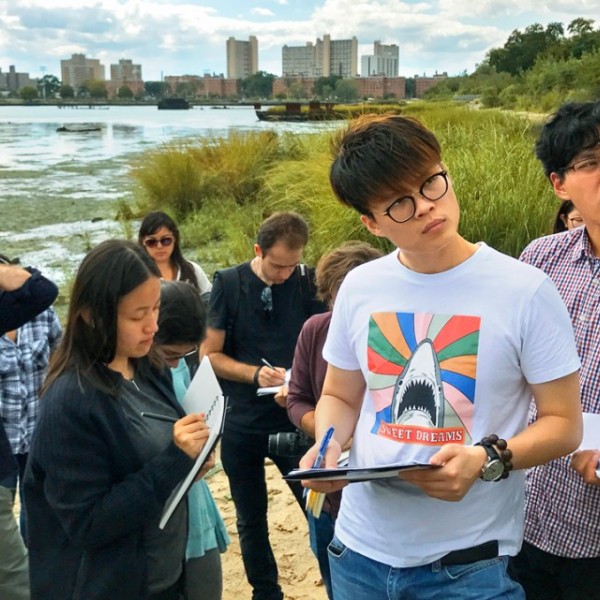 Students take notes on beach front