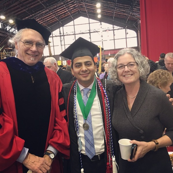 Sagar Chapagain stands at graduation with faculty and staff