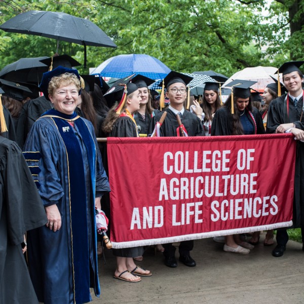 Graduates hold a banner saying "College of Agriculture and Life Sciences"