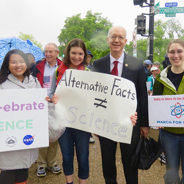 people holding up signs