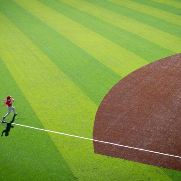 baseball player throwing ball on field