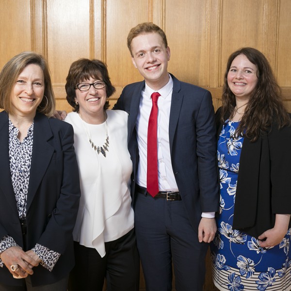 Kevin Kowalewski ’17, center, is joined by, from left, Dawn Chutkow, visiting professor of law; Cornell President Martha E. Pollack; and his mother, Julie Kowalewski