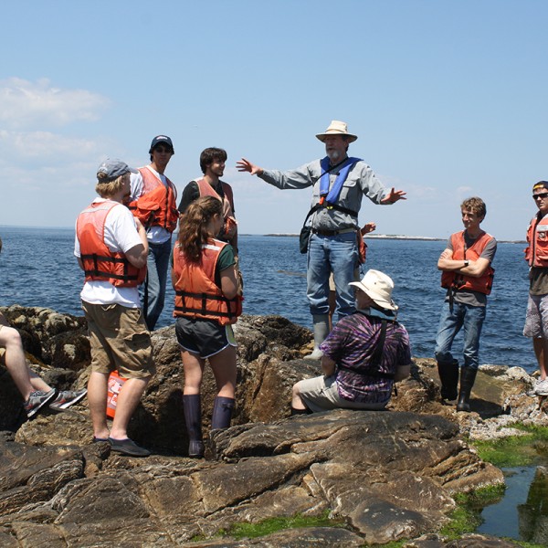 Jan Factor talks to student overlooking the ocean