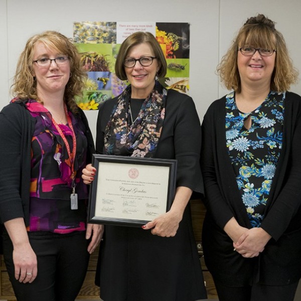 Cheryl Gombas stands with colleagues