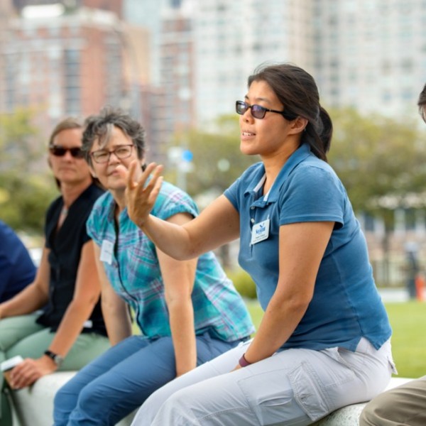 specialist speaks with NYC teachers in park