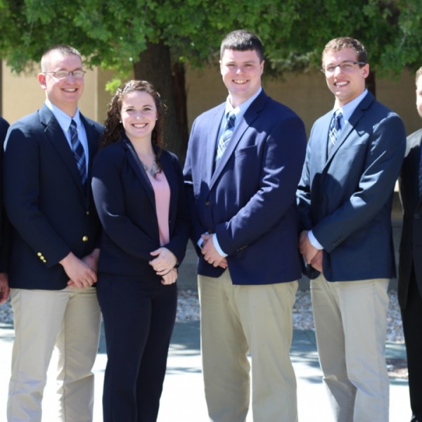 Various students standing and smiling