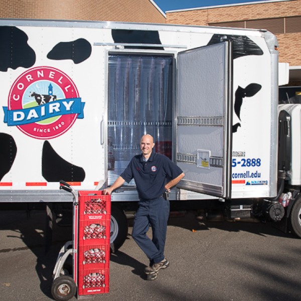 Chris Bush stands in front of a Cornell Dairy truck