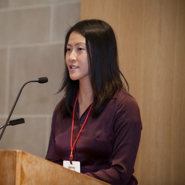 A woman speaks from behind a podium