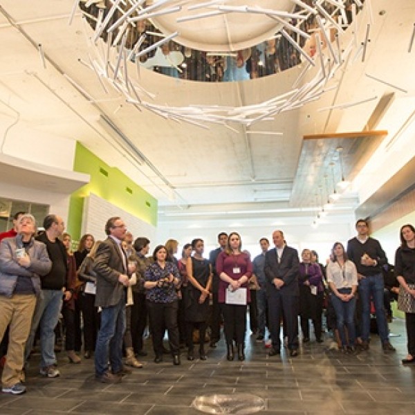 A crowd of people standing in a large room