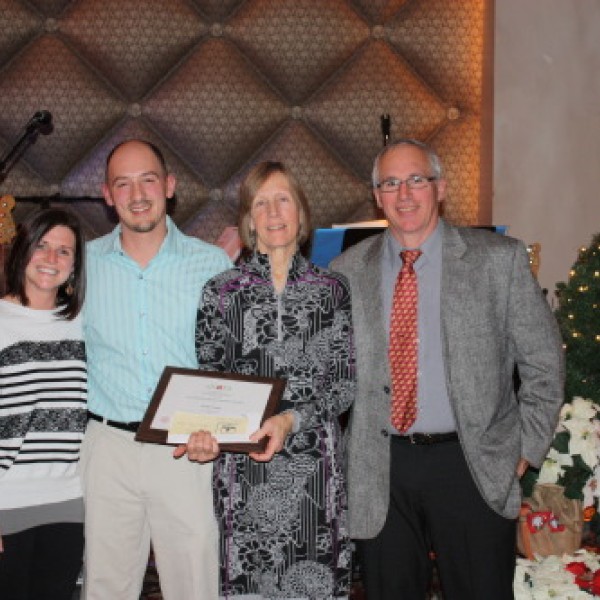 Four people pose for a photo at the NYSAES banquet