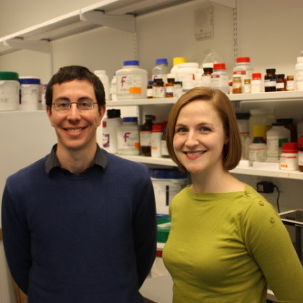 A man and a woman stand in a laboratory