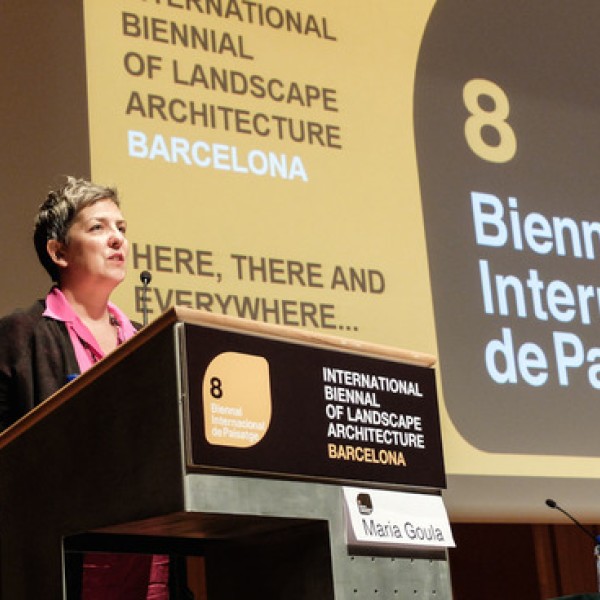 A woman gives a presentation while standing at a podium