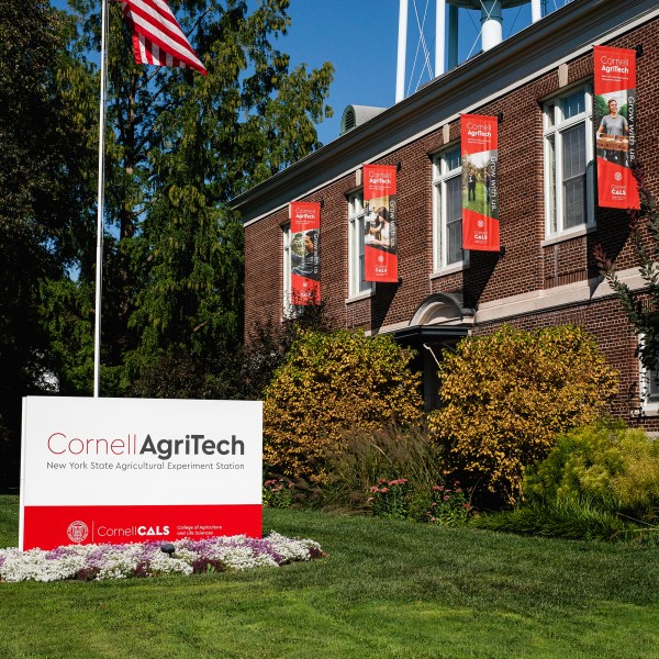 A large brick building with a sign out front