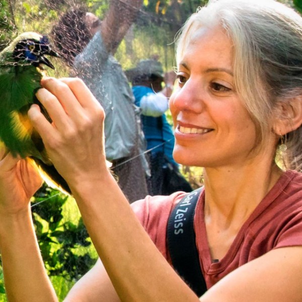 Amanda Rodewald, holds a bird. 