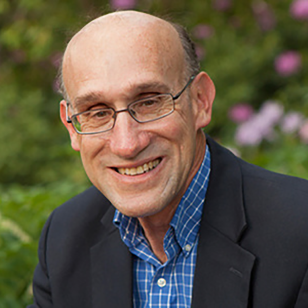 a profile picture of a man smiling