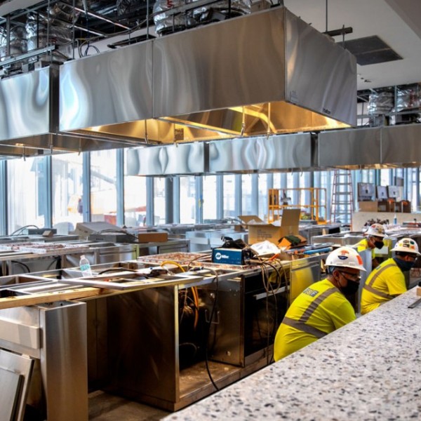 workers installing equipment in the future Discovery Kitchen
