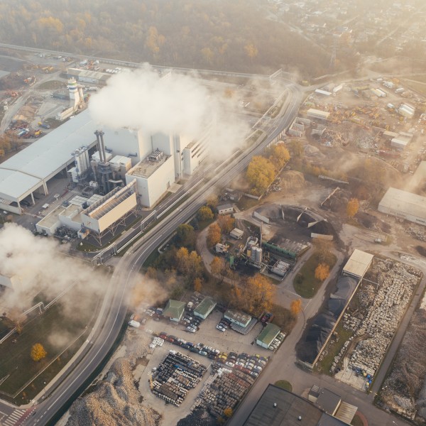 An arial view of an industrial plant giving off gas 