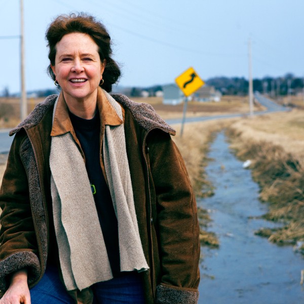Woman on roadside with overcoat