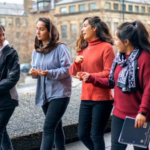 From left, Tamana Ahmadi, Sepehera Azami, Diana Ayubi and Simah Sahnosh walk outside Uris Hall.