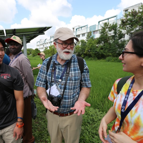 Teacher engages with two students on a trip to India