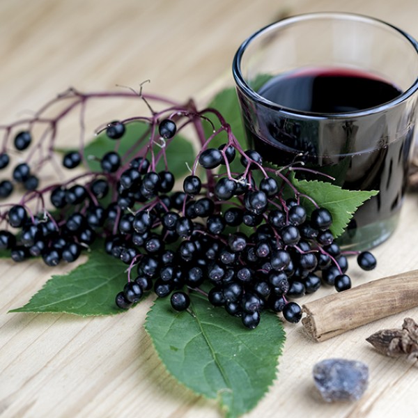 Elderberries and a glass of elderberry juice