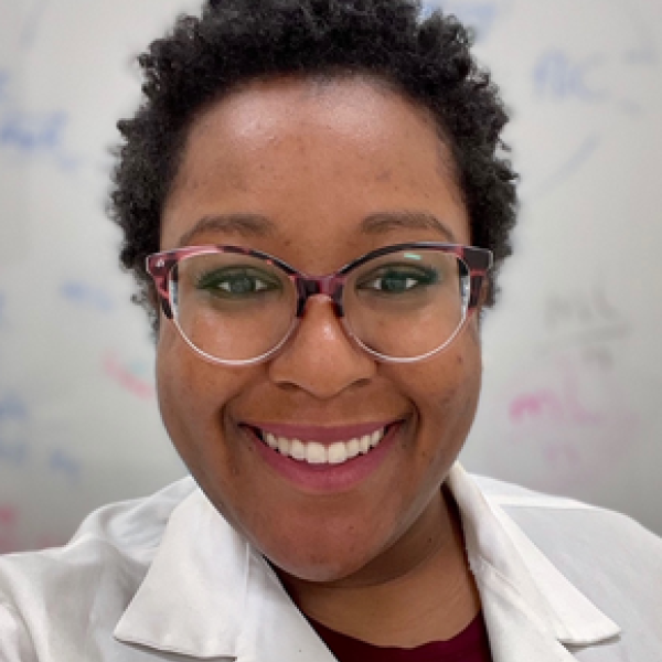 woman in lab coat with glasses