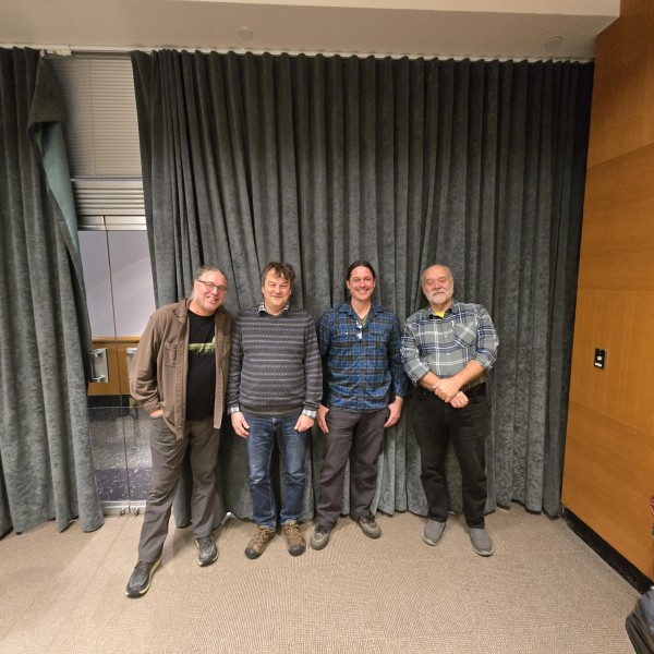 Four people standing next to each other