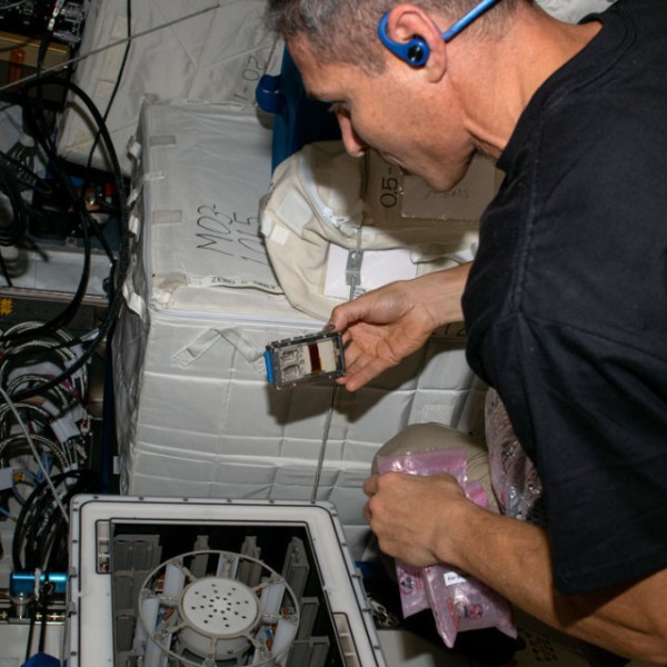 Michael Scott Hopkins performs a microgravity experiment on the International Space Station