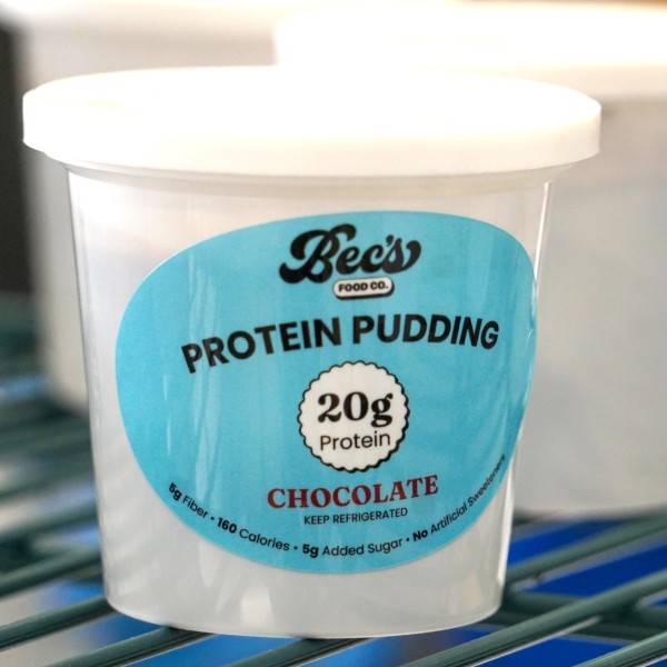 A white cup with a blue label on the side. 