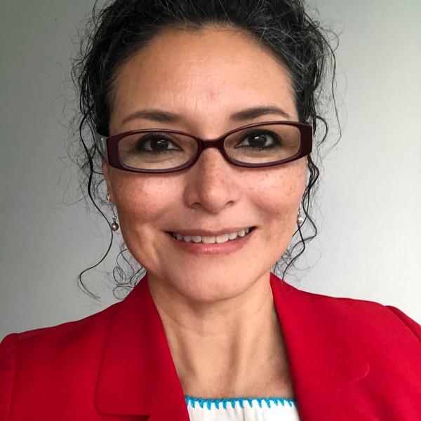 Portrait of a person wearing a red jacket and glasses.
